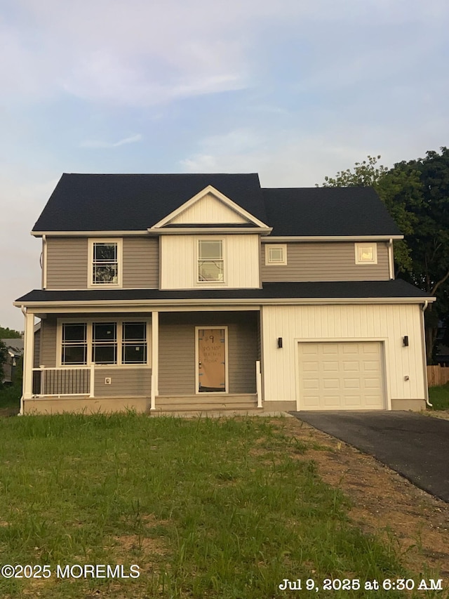9 Leifried Ln, Little Egg Harbor, NJ 08087 - view of front of property with asphalt driveway, a garage, and a porch