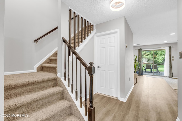 18 Remington Dr Unit 5, Freehold, NJ 07728 - staircase with wood finished floors, a textured ceiling, and recessed lighting