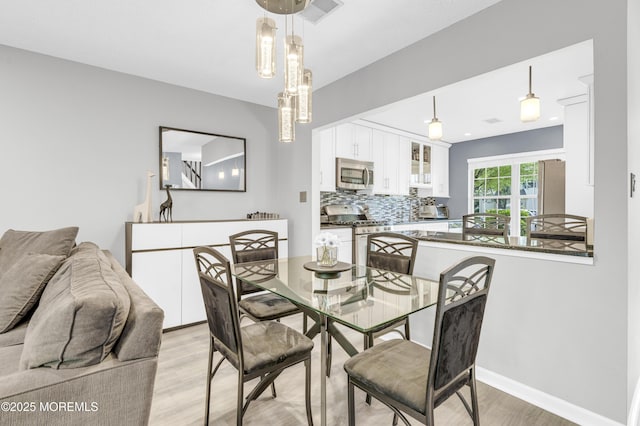 18 Remington Dr Unit 5, Freehold, NJ 07728 - dining area featuring light wood-style flooring and baseboards