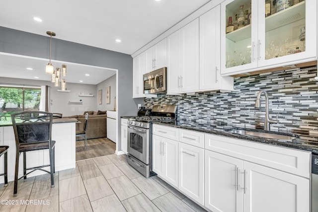 18 Remington Dr Unit 5, Freehold, NJ 07728 - kitchen with appliances with stainless steel finishes, white cabinets, tasteful backsplash, glass insert cabinets, and dark stone countertops