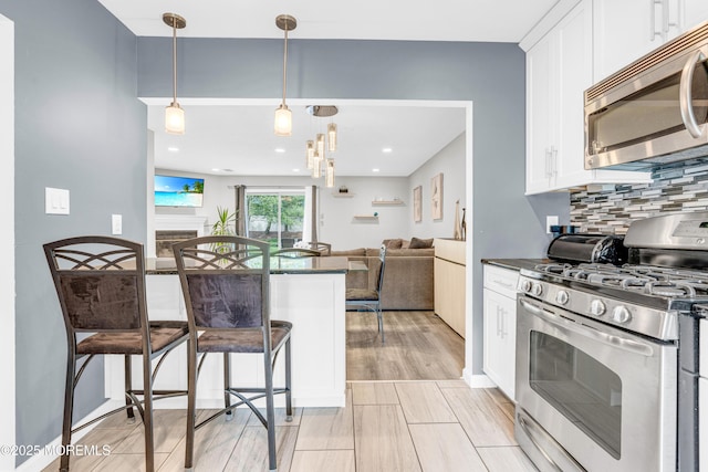 18 Remington Dr Unit 5, Freehold, NJ 07728 - kitchen with appliances with stainless steel finishes, dark countertops, open floor plan, white cabinets, and recessed lighting