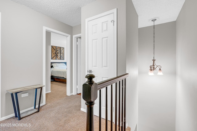 18 Remington Dr Unit 5, Freehold, NJ 07728 - hall featuring a textured ceiling, an upstairs landing, and light colored carpet