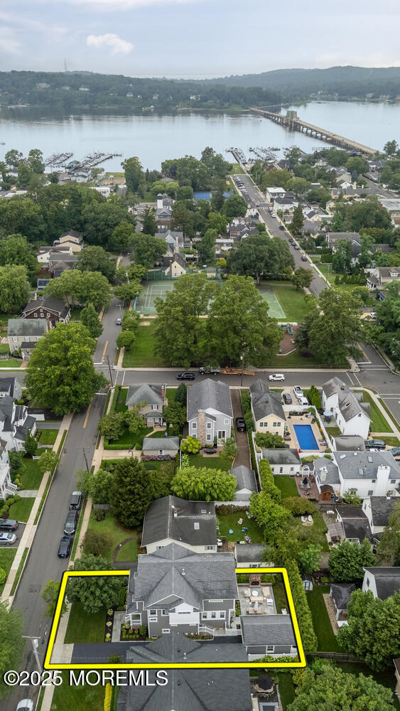 29 Allen St, Rumson, NJ 07760 - aerial perspective of suburban area featuring property parcel outlined, a large body of water, and a notable bridge
