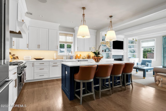29 Allen St, Rumson, NJ 07760 - kitchen with open floor plan, a kitchen island, light countertops, dark wood-style flooring, and white cabinets