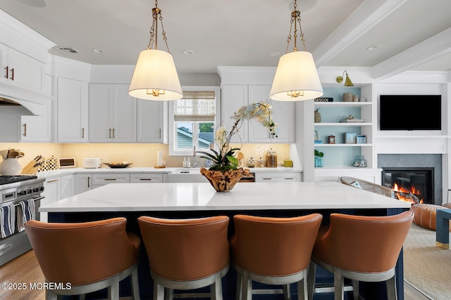 29 Allen St, Rumson, NJ 07760 - kitchen featuring light countertops, a kitchen island, high end stainless steel range, and white cabinets