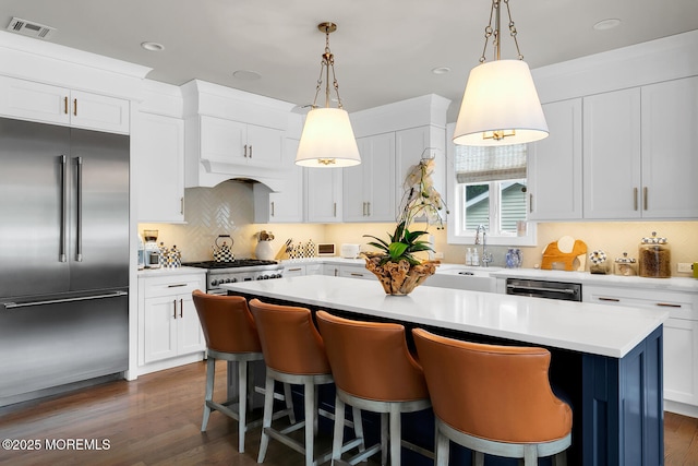 29 Allen St, Rumson, NJ 07760 - kitchen with stainless steel appliances, a kitchen island, light countertops, a breakfast bar area, and recessed lighting