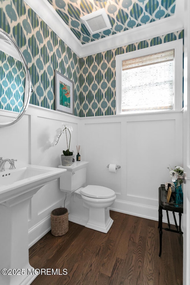 29 Allen St, Rumson, NJ 07760 - half bath featuring wallpapered walls, a decorative wall, wood finished floors, and crown molding
