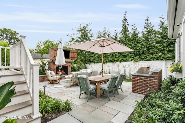 29 Allen St, Rumson, NJ 07760 - view of patio featuring an outdoor brick fireplace, outdoor dining space, and area for grilling