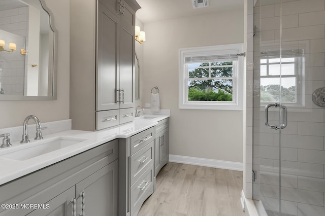 29 Allen St, Rumson, NJ 07760 - full bathroom with plenty of natural light, double vanity, a shower stall, and wood finished floors