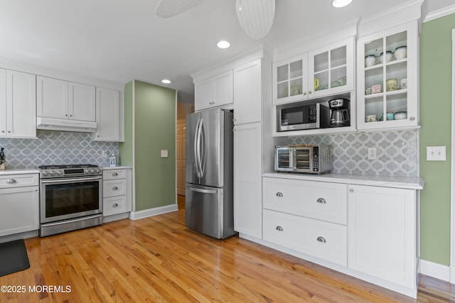 623 Forecastle Ave, Beachwood, NJ 08722 - kitchen with stainless steel appliances, under cabinet range hood, light countertops, white cabinets, and recessed lighting
