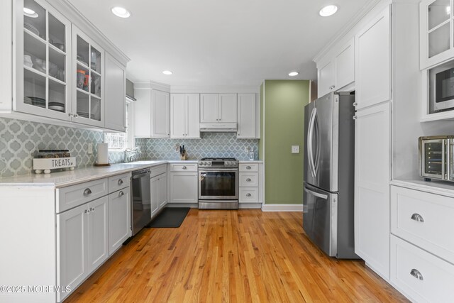 623 Forecastle Ave, Beachwood, NJ 08722 - kitchen with stainless steel appliances, light countertops, backsplash, light wood-style flooring, and recessed lighting