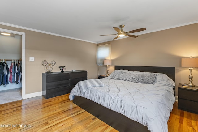 623 Forecastle Ave, Beachwood, NJ 08722 - bedroom featuring wood finished floors, crown molding, ceiling fan, and a walk in closet