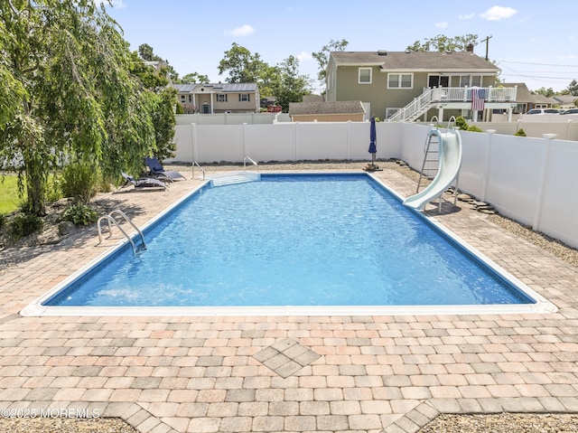 623 Forecastle Ave, Beachwood, NJ 08722 - view of swimming pool with a water slide, a fenced backyard, and a patio