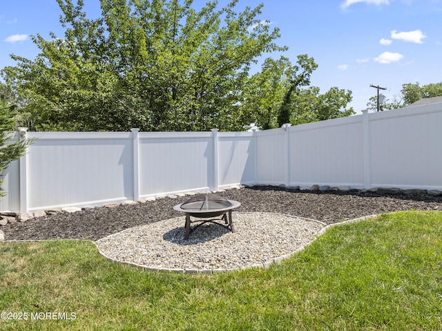 623 Forecastle Ave, Beachwood, NJ 08722 - fenced backyard featuring an outdoor fire pit