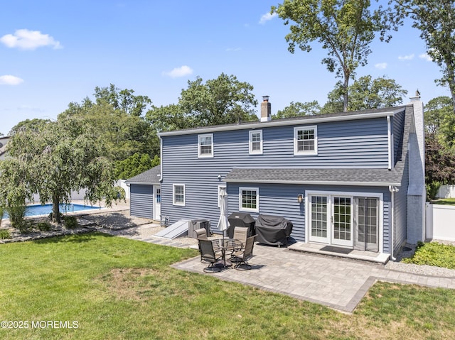 623 Forecastle Ave, Beachwood, NJ 08722 - back of property featuring a chimney, a lawn, a patio, an outdoor pool, and a shingled roof