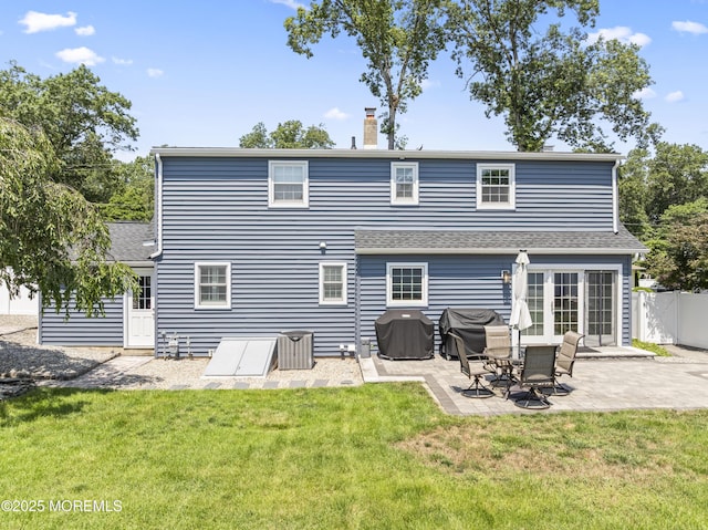 623 Forecastle Ave, Beachwood, NJ 08722 - back of property featuring a patio, a chimney, and roof with shingles