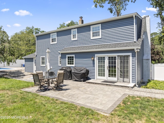 623 Forecastle Ave, Beachwood, NJ 08722 - back of property with a chimney, roof with shingles, and a patio area