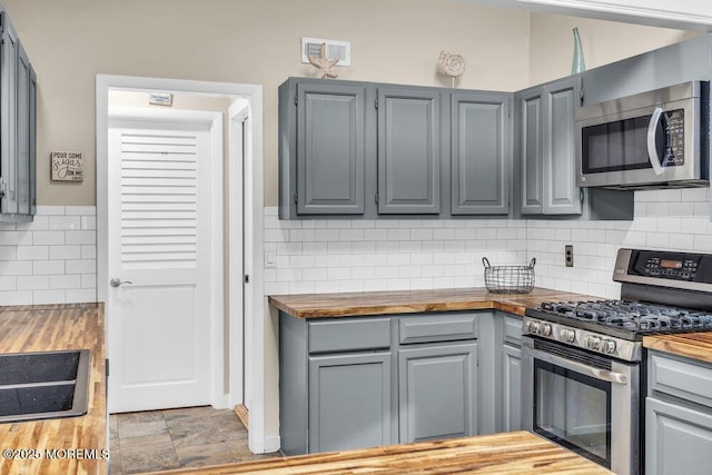 208 Chatham Ln, Point Pleasant, NJ 08742 - kitchen featuring appliances with stainless steel finishes, wooden counters, gray cabinets, and decorative backsplash