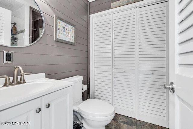208 Chatham Ln, Point Pleasant, NJ 08742 - bathroom with a closet, wooden walls, vanity, and stone finish flooring