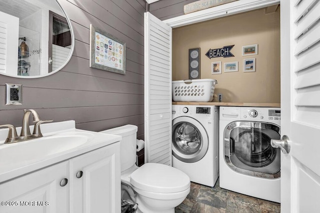 208 Chatham Ln, Point Pleasant, NJ 08742 - bathroom with washer and clothes dryer, wooden walls, vanity, and stone finish floors