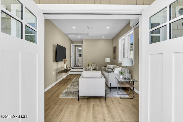 208 Chatham Ln, Point Pleasant, NJ 08742 - living room with light wood-style flooring, a wall unit AC, attic access, and recessed lighting