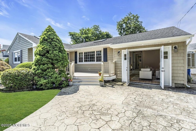 208 Chatham Ln, Point Pleasant, NJ 08742 - view of front of property with a front lawn, a patio, and roof with shingles