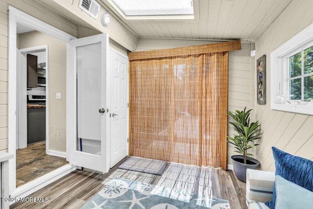 208 Chatham Ln, Point Pleasant, NJ 08742 - bathroom featuring vaulted ceiling, wood finished floors, wood walls, and a skylight