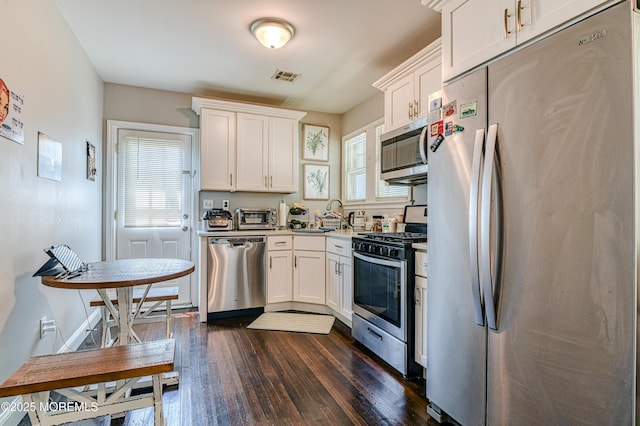 241 Hancock Ave, Seaside Heights, NJ 08751 - kitchen featuring stainless steel appliances, dark wood-style floors, and white cabinets