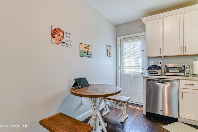 241 Hancock Ave, Seaside Heights, NJ 08751 - kitchen featuring stainless steel dishwasher, dark wood-style floors, light countertops, and white cabinetry