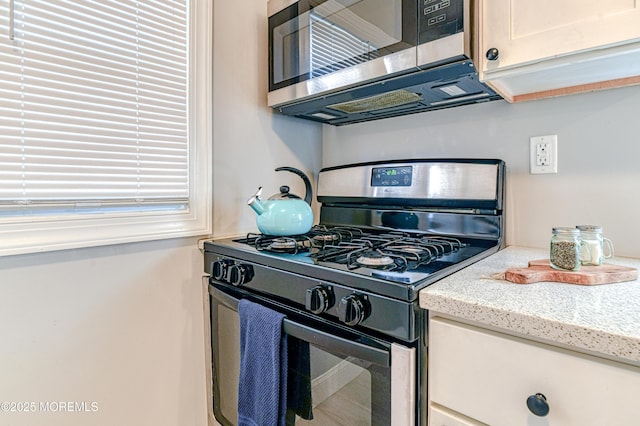241 Hancock Ave, Seaside Heights, NJ 08751 - kitchen with gas stove, stainless steel microwave, and light stone counters