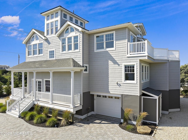 41A Long Beach Blvd, Long Beach Twp, NJ 08008 - view of front of property with covered porch, an attached garage, a balcony, decorative driveway, and a shingled roof