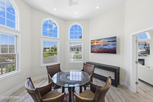 41A Long Beach Blvd, Long Beach Twp, NJ 08008 - dining area featuring light wood-style flooring, a high ceiling, ceiling fan, recessed lighting, and a glass covered fireplace