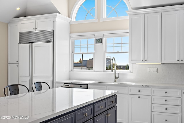 41A Long Beach Blvd, Long Beach Twp, NJ 08008 - kitchen with paneled fridge, white cabinetry, light stone counters, recessed lighting, and vaulted ceiling