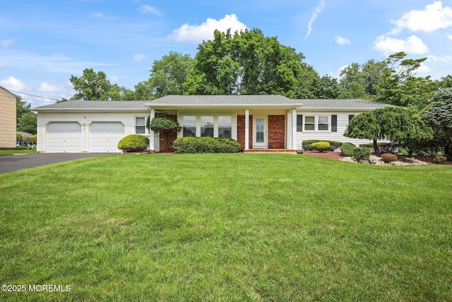 6 Pamela St, Marlboro, NJ 07746 - ranch-style house with driveway, a front yard, a garage, and brick siding
