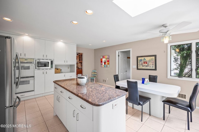 6 Pamela St, Marlboro, NJ 07746 - kitchen with appliances with stainless steel finishes, a kitchen island, light tile patterned floors, white cabinets, and recessed lighting