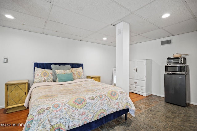 505 Moore Rd, Neptune Township, NJ 07753 - bedroom with a drop ceiling, freestanding refrigerator, stone finish flooring, and recessed lighting