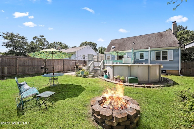 505 Moore Rd, Neptune Township, NJ 07753 - rear view of house featuring an outdoor fire pit, a deck, a fenced backyard, a chimney, and roof with shingles