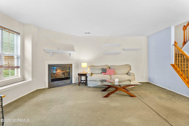 117 Lexington Ct, Holmdel, NJ 07733 - carpeted living area with stairway and a fireplace with flush hearth