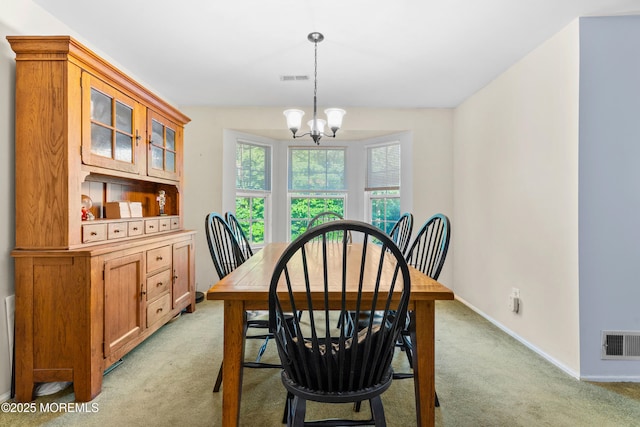117 Lexington Ct, Holmdel, NJ 07733 - dining area with light colored carpet and a chandelier