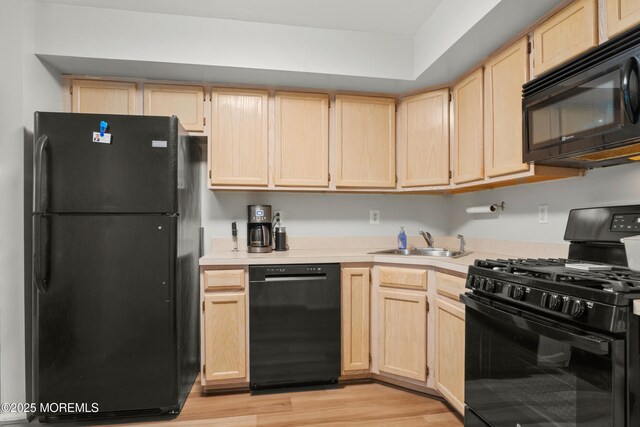 117 Lexington Ct, Holmdel, NJ 07733 - kitchen with black appliances, light brown cabinetry, light countertops, and light wood finished floors