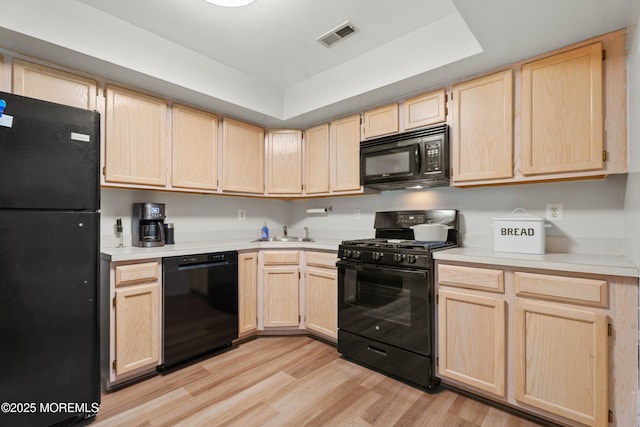 117 Lexington Ct, Holmdel, NJ 07733 - kitchen with black appliances, light brown cabinets, light wood-type flooring, and light countertops