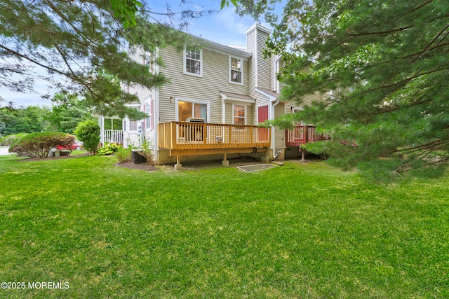117 Lexington Ct, Holmdel, NJ 07733 - back of property with a chimney, a deck, and a yard
