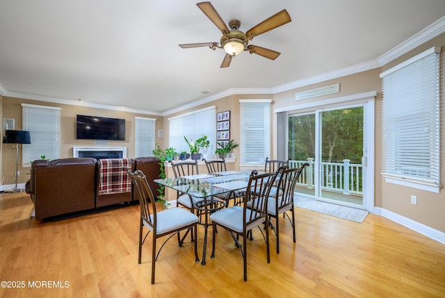 235 Leesville Rd, Jackson, NJ 08527 - dining space with light wood finished floors, ceiling fan, crown molding, and a fireplace