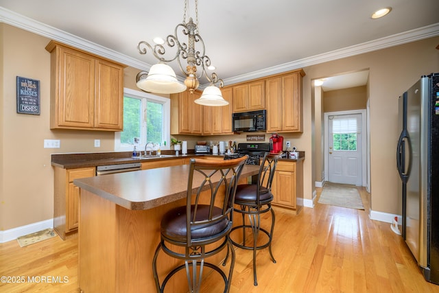 235 Leesville Rd, Jackson, NJ 08527 - kitchen with black appliances, plenty of natural light, light wood-type flooring, a breakfast bar, and ornamental molding
