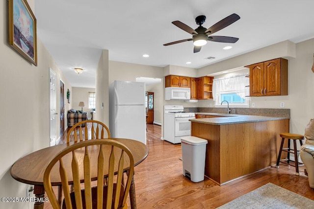 119 Barbados Dr S, Toms River, NJ 08757 - kitchen with white appliances, a peninsula, brown cabinets, light wood finished floors, and recessed lighting