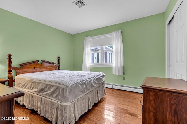 119 Barbados Dr S, Toms River, NJ 08757 - bedroom featuring baseboard heating, a closet, and wood finished floors