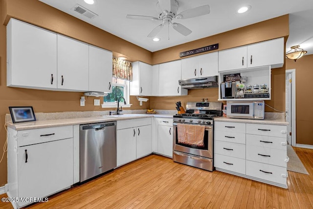 7 Crest Rd, Jackson, NJ 08527 - kitchen with appliances with stainless steel finishes, under cabinet range hood, light countertops, light wood-style flooring, and recessed lighting
