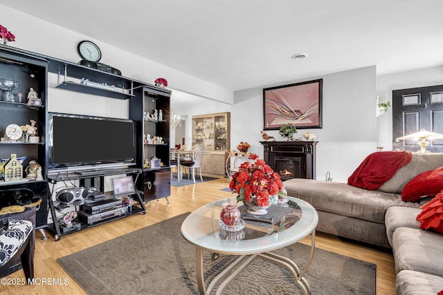 7 Beaverbrook Dr, Toms River, NJ 08757 - living area featuring a glass covered fireplace and light wood-style flooring
