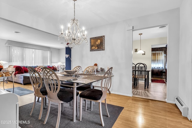 7 Beaverbrook Dr, Toms River, NJ 08757 - dining area with baseboard heating, a chandelier, light wood-style floors, and plenty of natural light