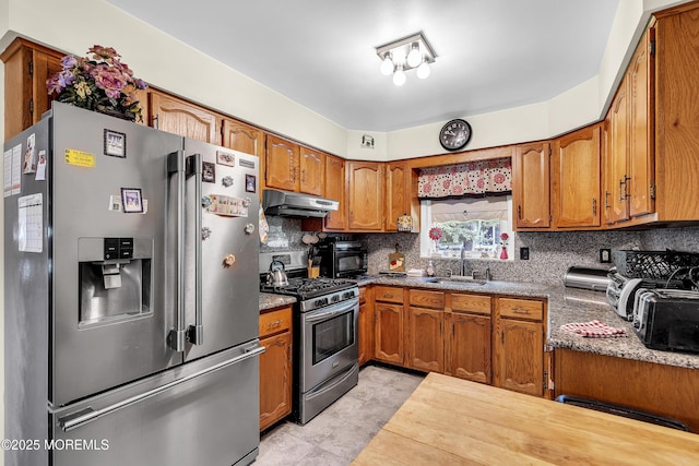 7 Beaverbrook Dr, Toms River, NJ 08757 - kitchen with stainless steel appliances, under cabinet range hood, brown cabinetry, and backsplash